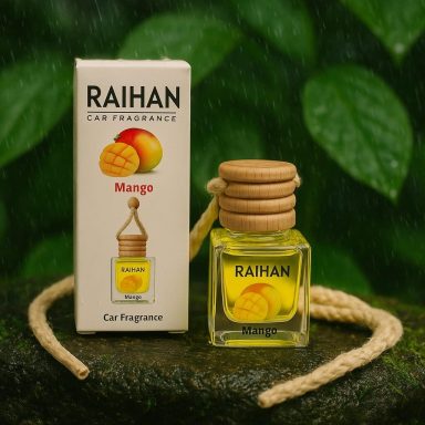 Raihan Car Diffuser Mango fragrance bottle with wooden cap and box, set against green foliage.